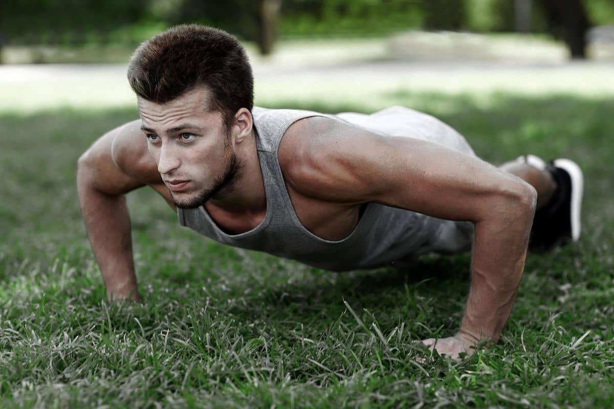 The Best Weekly Calisthenics Workout Plan (Free PDF) A man doing pushup, a part of the Calisthenics Workout Program PDF