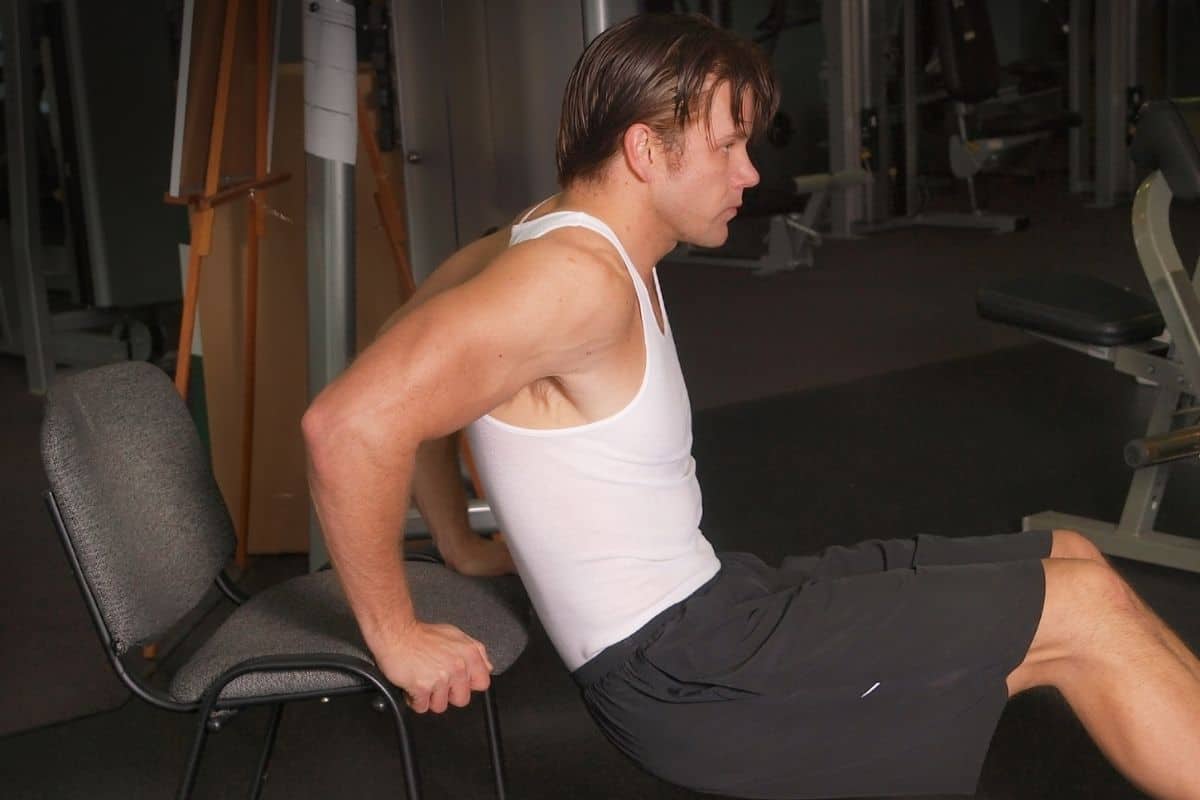 Chair dips is one of the best bodyweight arms workouts you can do at home