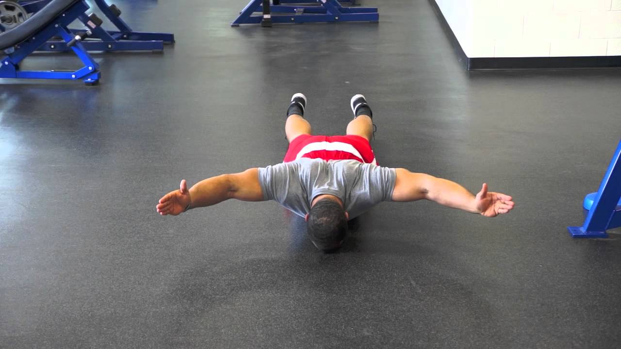 Lying Y raises, one of the bodyweight trapezius exercises you can do at home