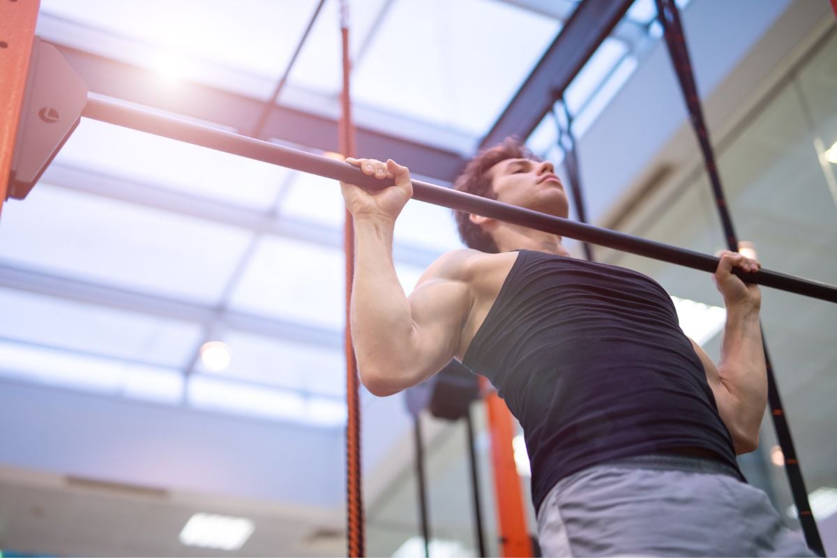 A man doing pullups, a Calisthenics back exercise