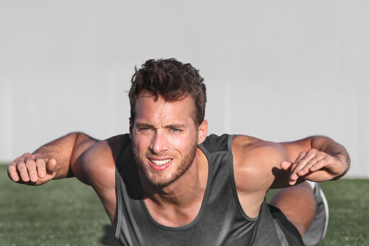 Calisthenics Back Workout (12 Best Exercises) A man doing Superman Pull, a calisthenics lower back exercise