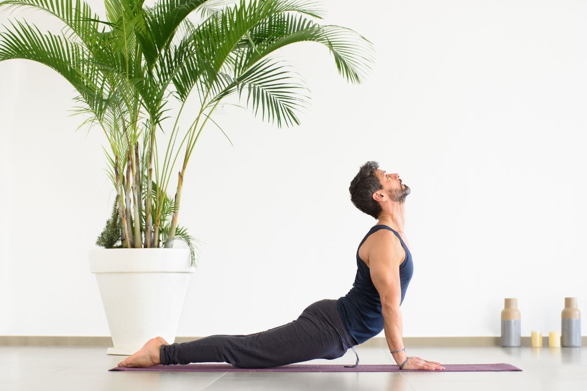 12 Best Isometric Ab Exercises and Core Workouts A man doing the Upward Facing Dog pose, an isometric abdominal exercise.